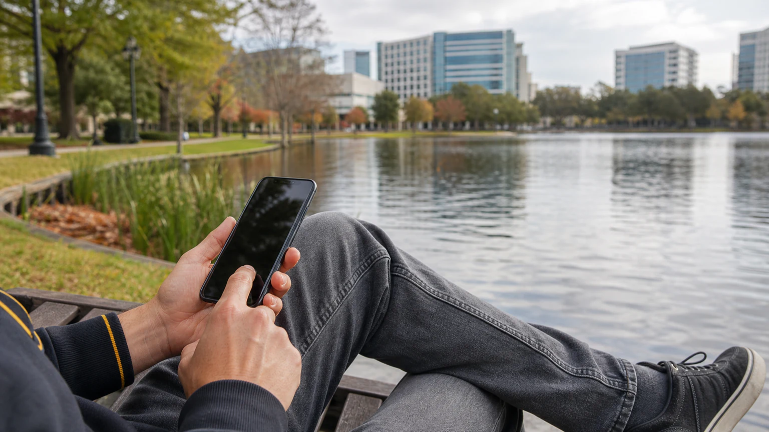 Altamonte Springs customer using a repaired smartphone near a lakeside park