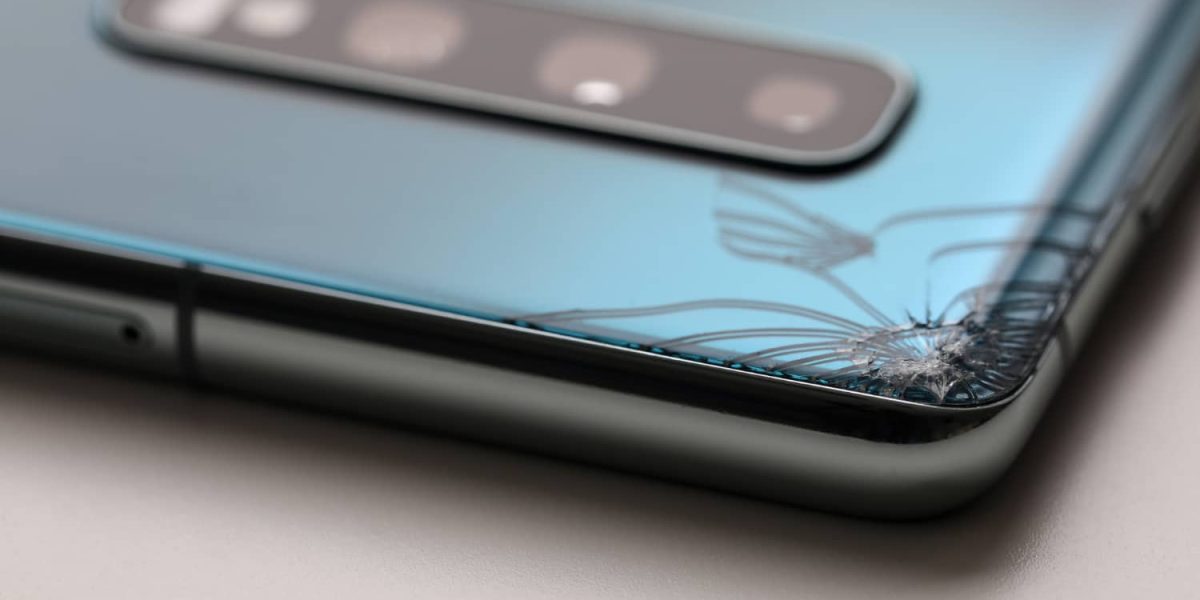 modern-smartphone-lying-table-with-crack-corner-close-up-1